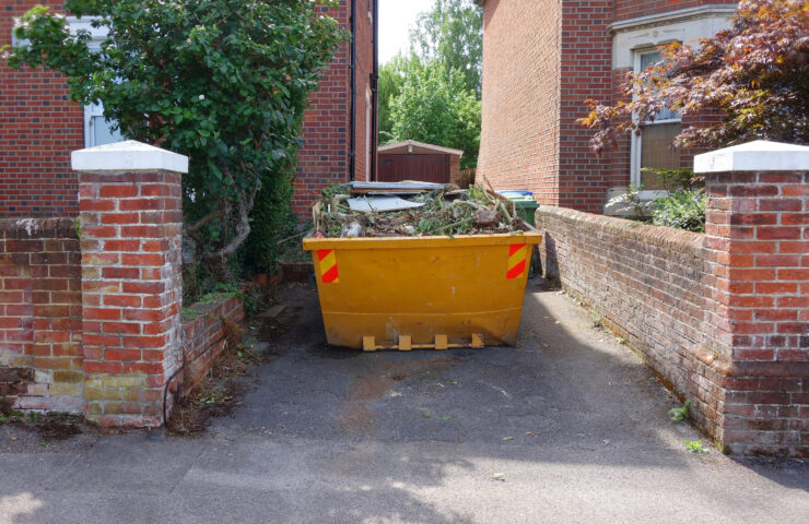 An image of a skip filled with garden waste.